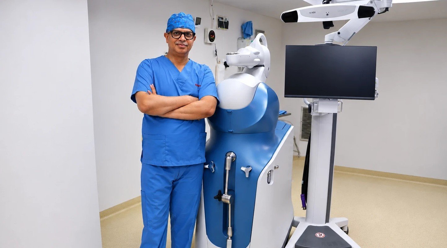 Dr. Dhananjay Gupta with a robotic-arm system for joint replacement